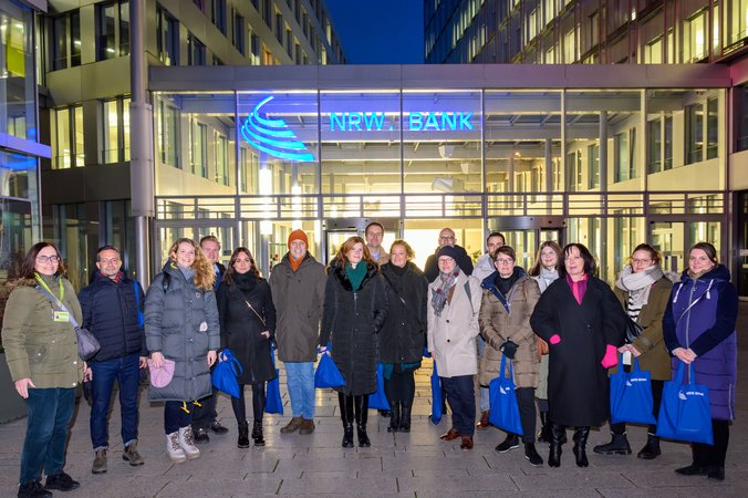 Öffnet eine Lightbox: Gruppenbild vor dem Gebäude der NRW.BANK 